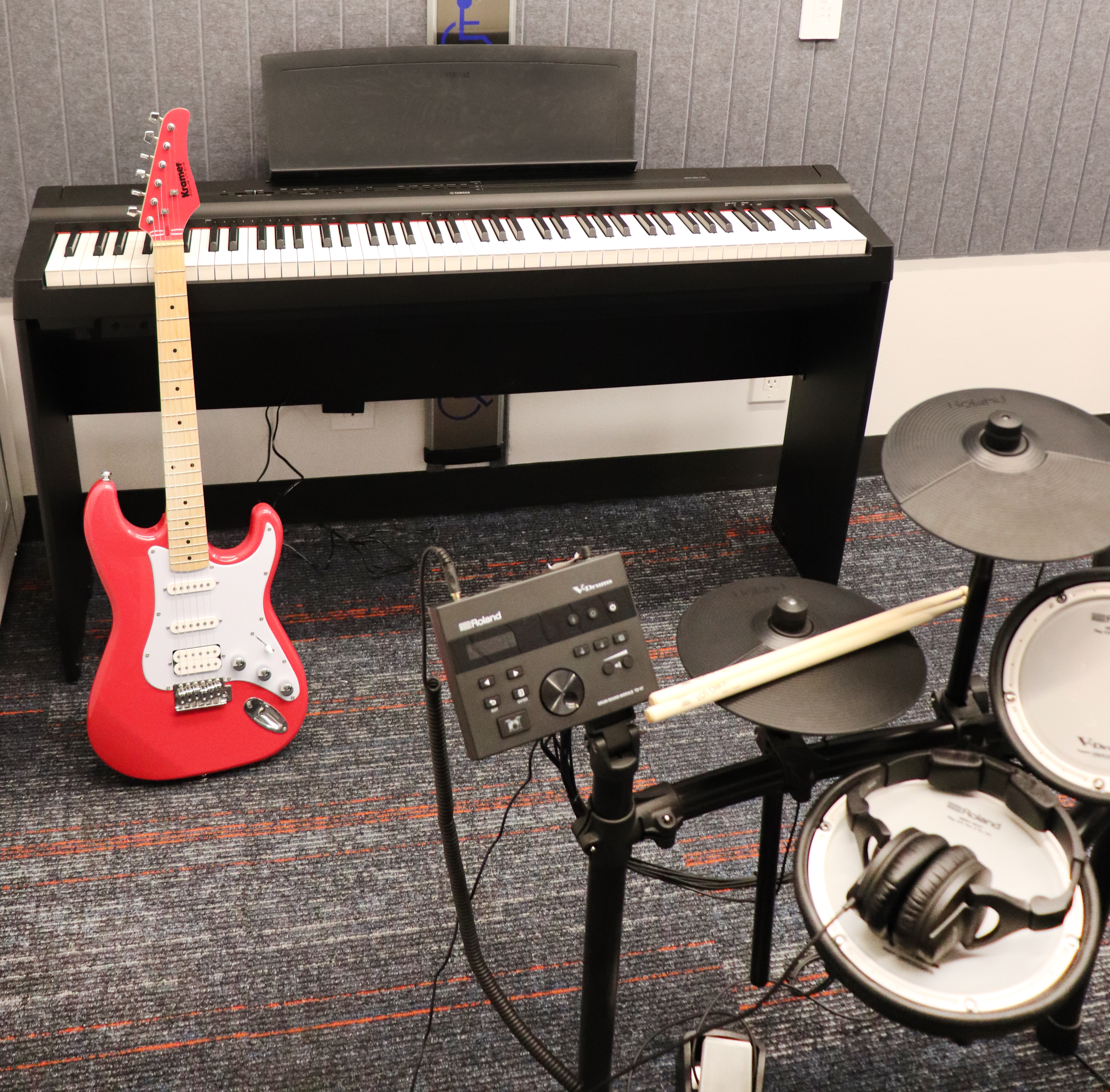 Makerspace musical instruments, including a digital piano, electric guitar, and electric drum set.